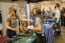 Two females shaking hands at the Cal Poly Construction Management 2021 Fall Career Fair